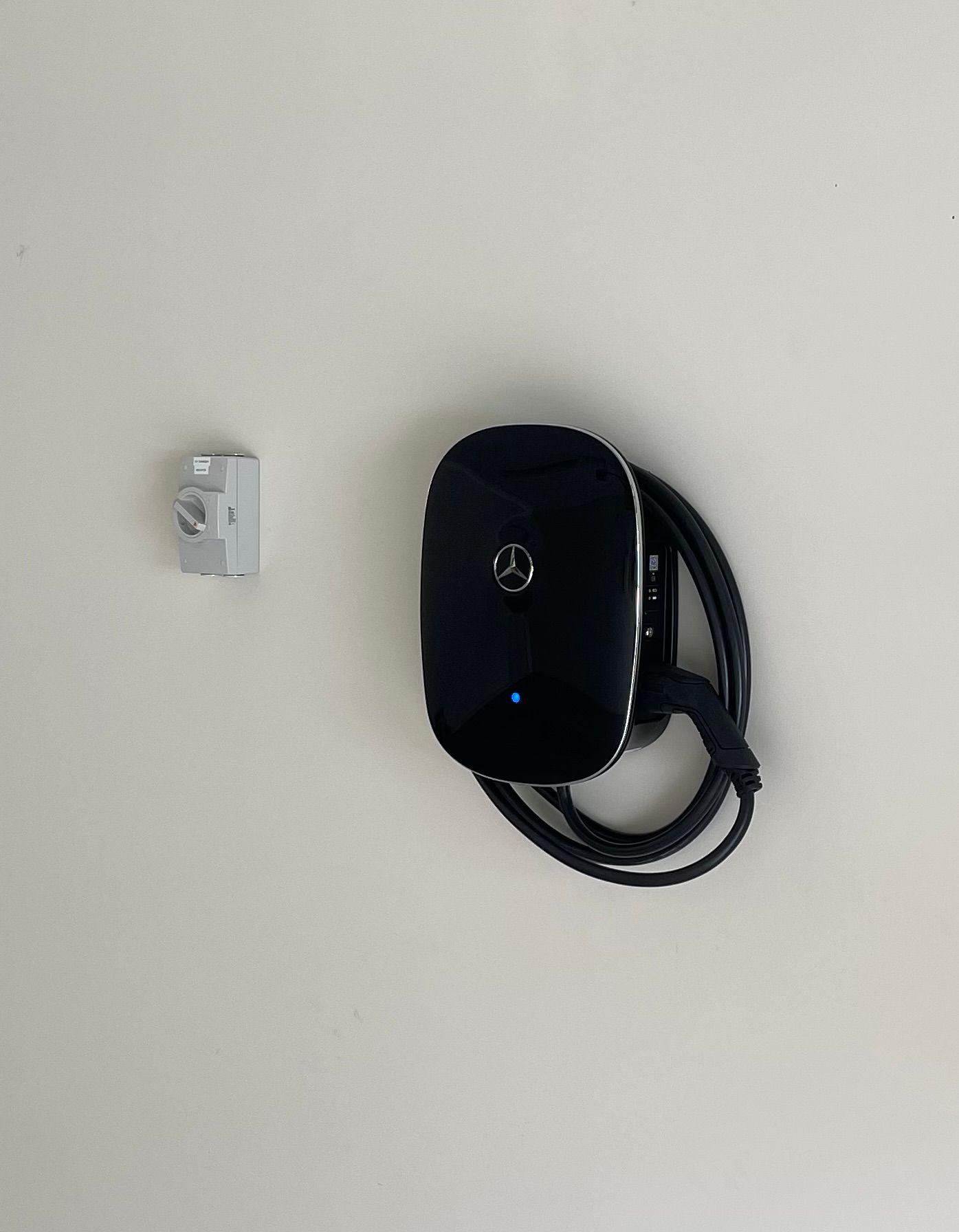 Black Mercedes-Benz EV Charger Mounted on a White Wall — Higgins Electrical in Landsborough, QLD