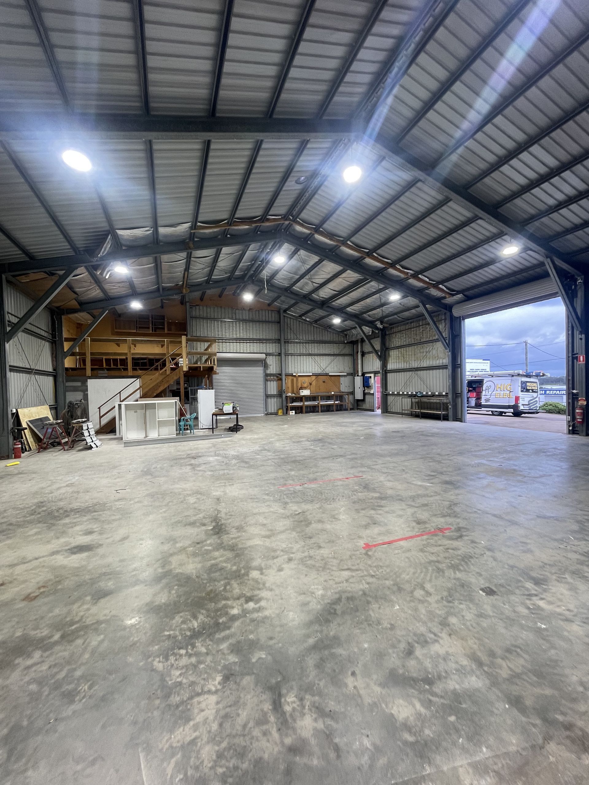 Empty Warehouse Interior With Metal Framework, Concrete Floor — Higgins Electrical in Glenview, QLD
