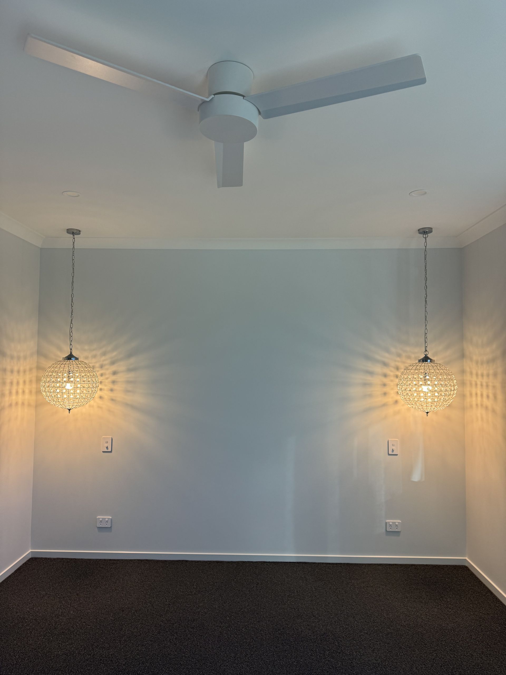 Room With a Ceiling Fan and Two Crystal Pendant Lights — Higgins Electrical in Glenview, QLD