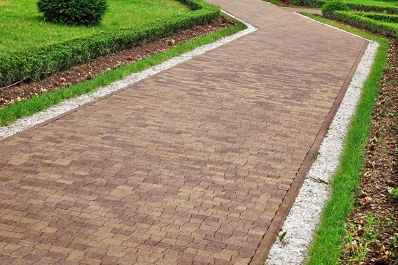 view of a brickwork paving with garden landscaping 