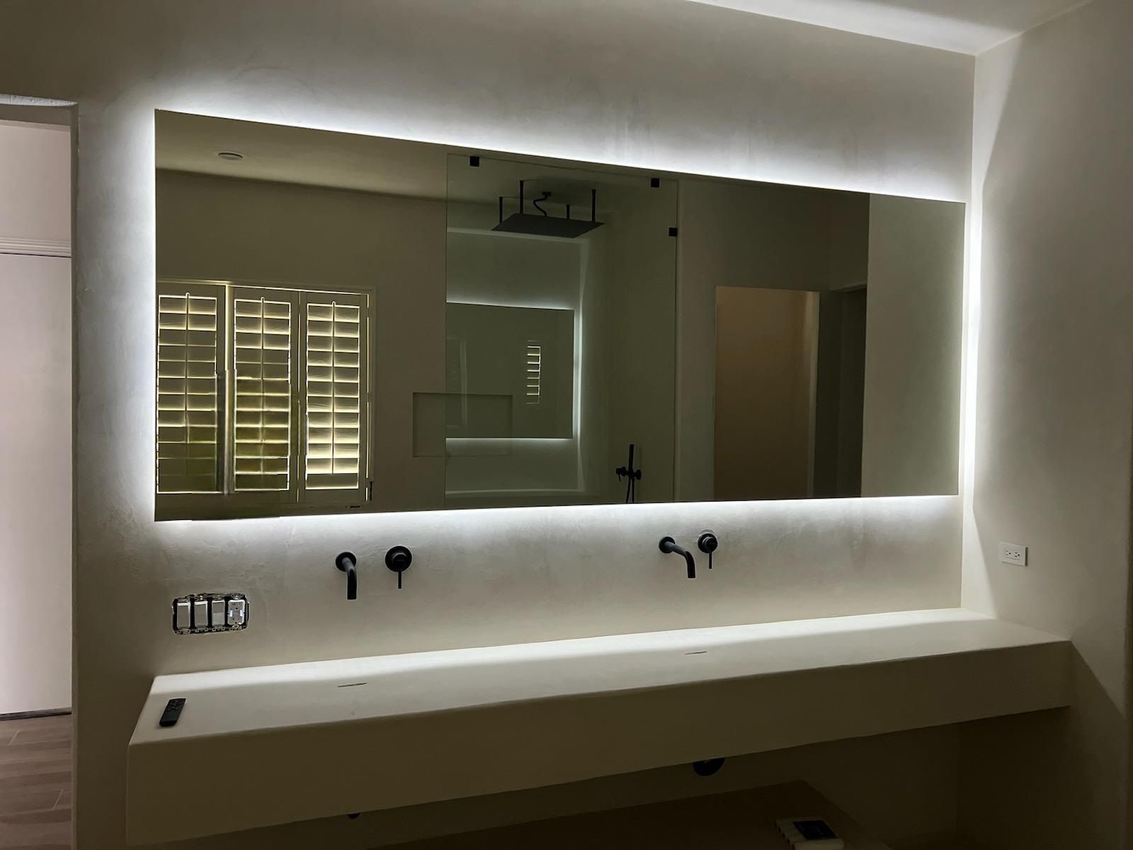 A bathroom with two sinks and a large mirror