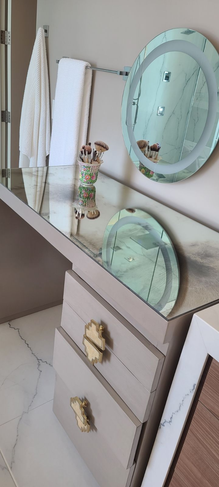 A bathroom vanity with a mirror and drawers.