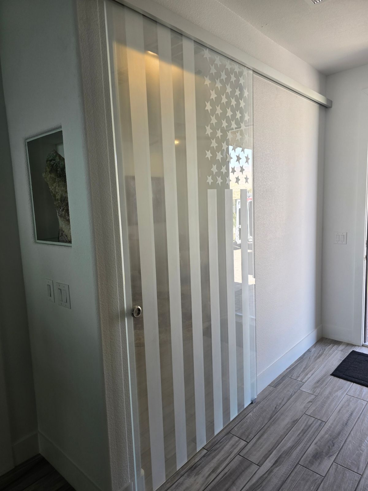 A sliding glass door with an american flag on it.
