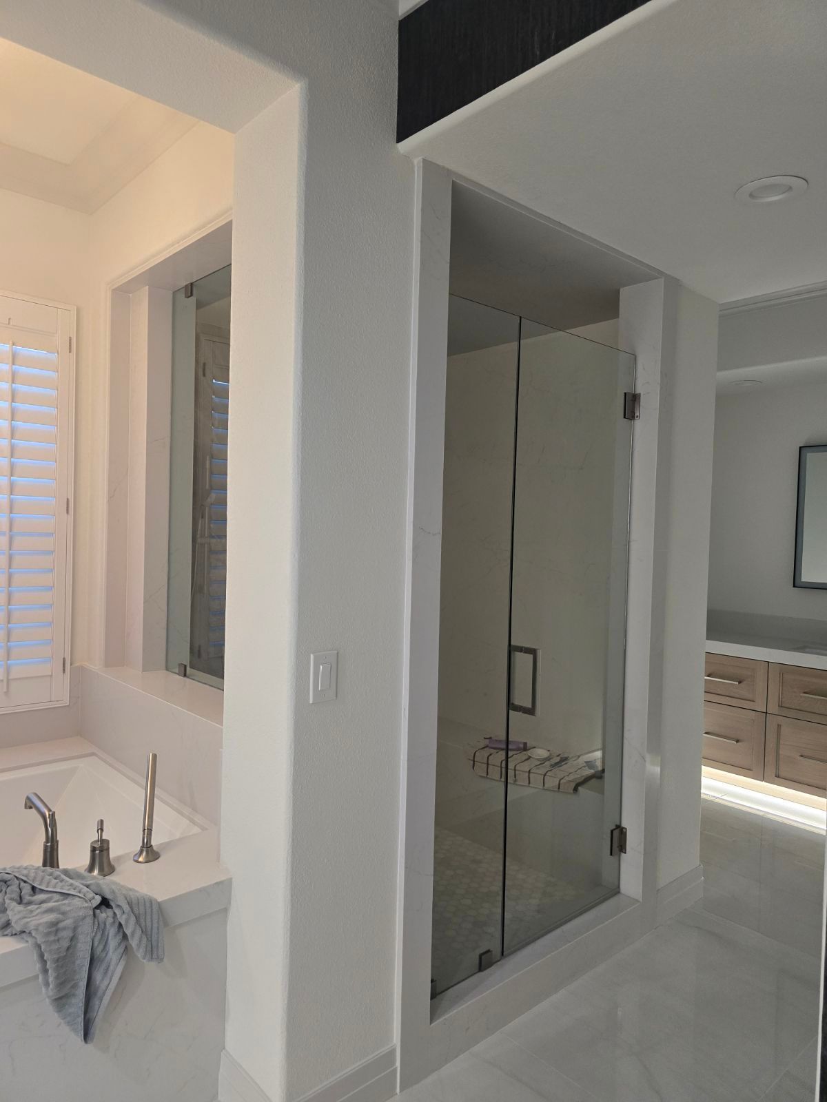 A bathroom with a bathtub and a walk in shower.