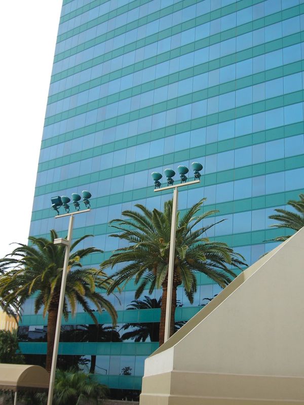A tall building with palm trees in front of it