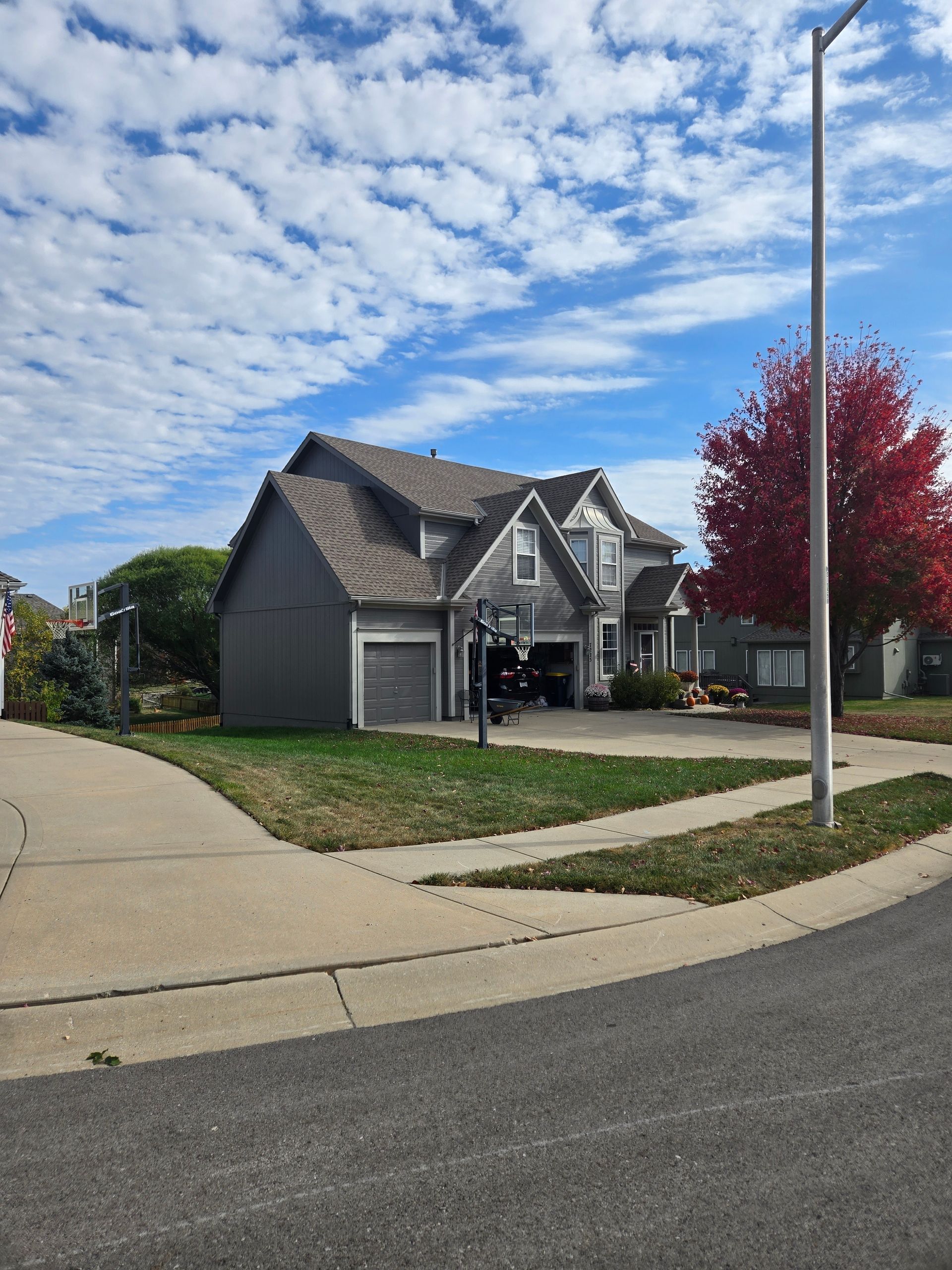 A large house is sitting on the corner of a street.