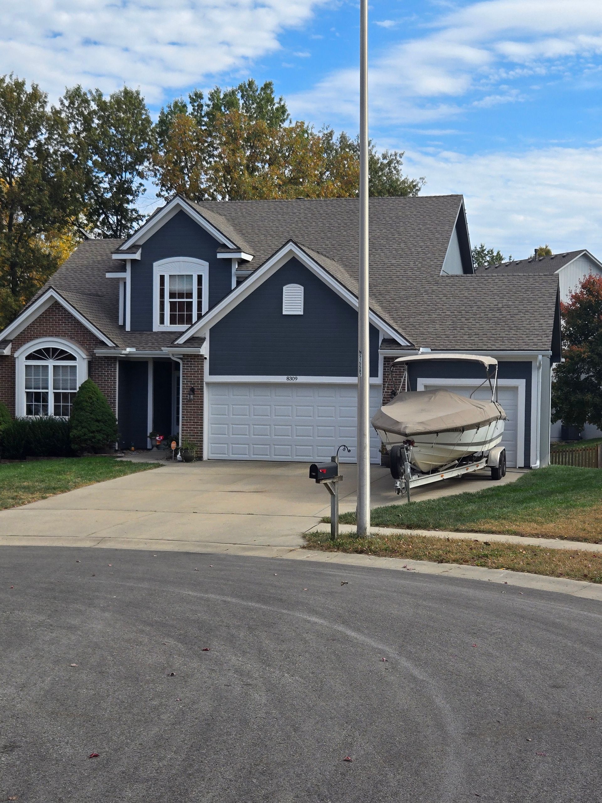 A large house with a boat in the garage