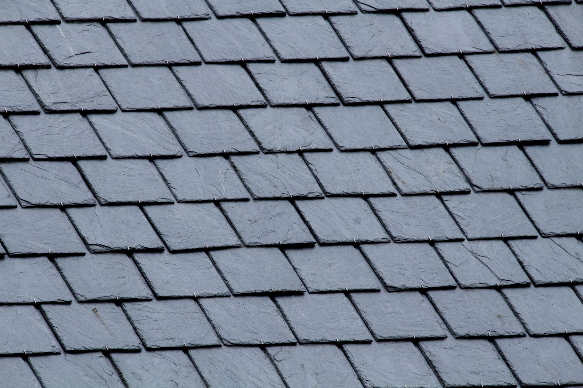 A close up of a roof with square tiles