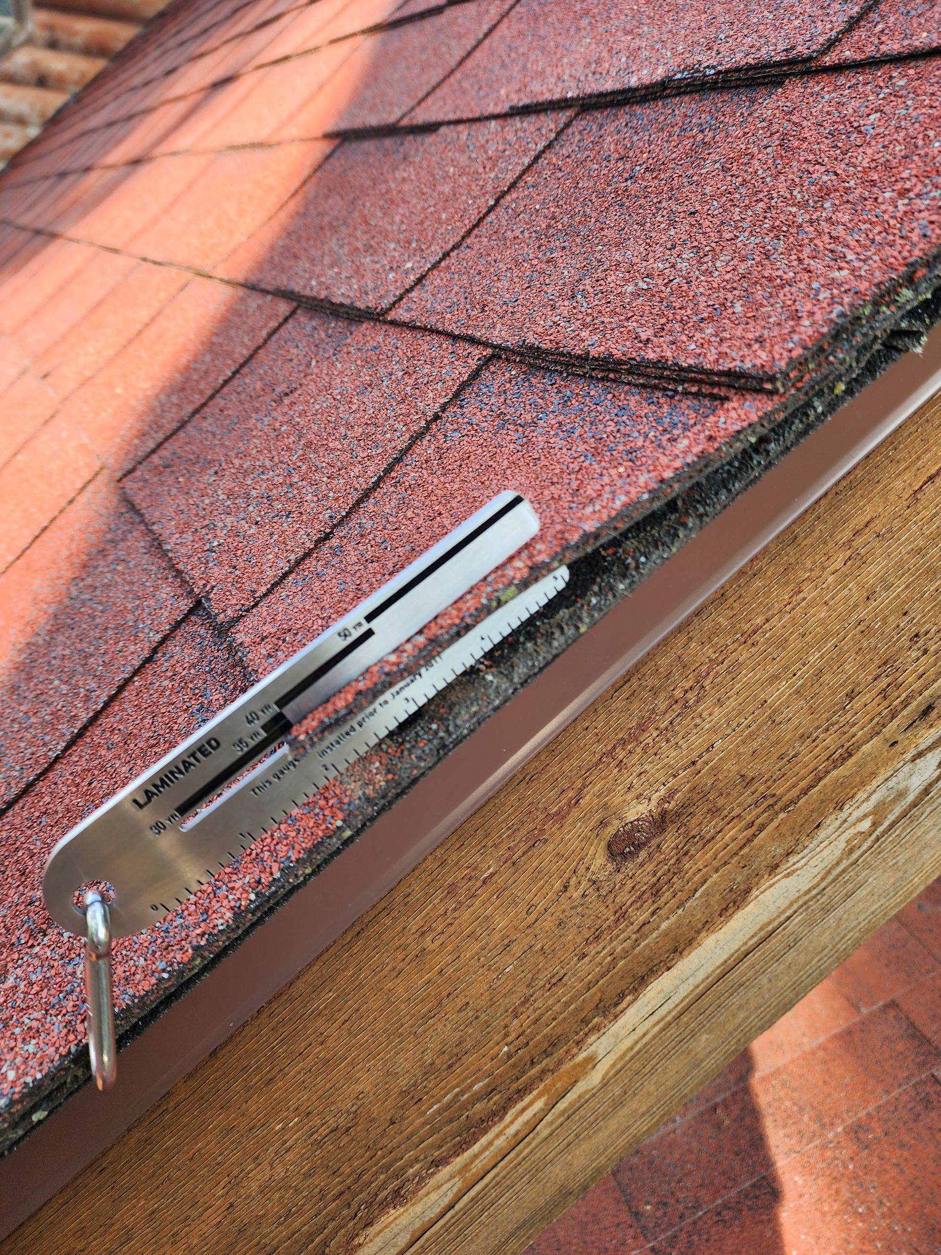 A close up of a roof with a tool on it.