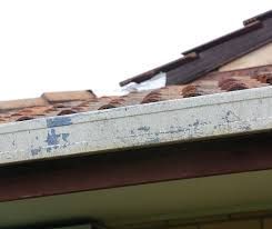 A close up of a roof with a gutter on it.