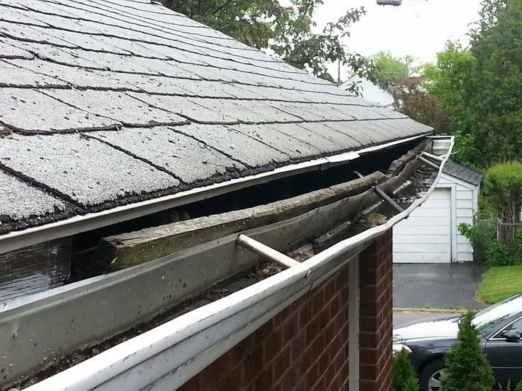 A close up of a gutter on a roof of a house.