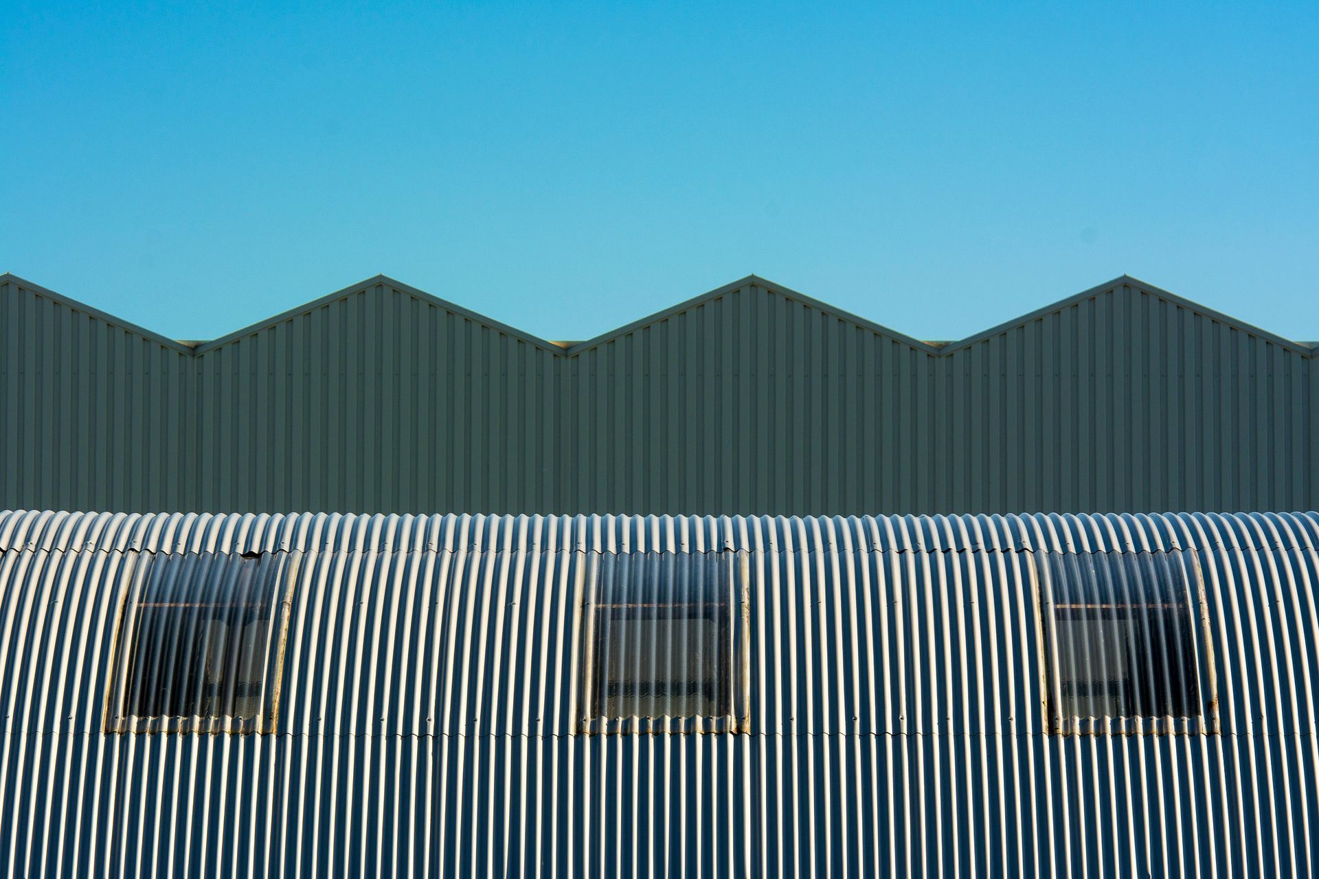 A building with a striped roof and a blue sky in the background.