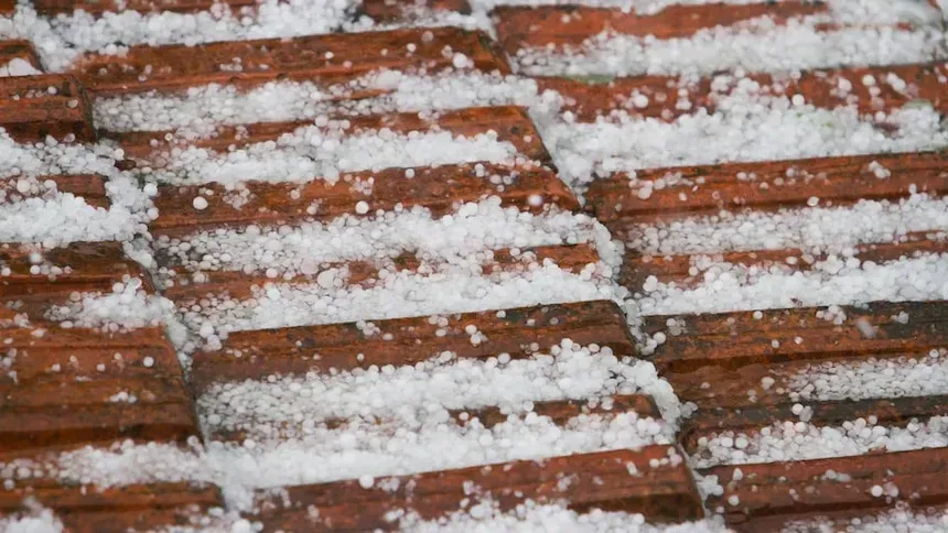 A close up of a roof with hail on it
