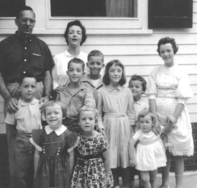 A black and white photo of a family posing for a picture
