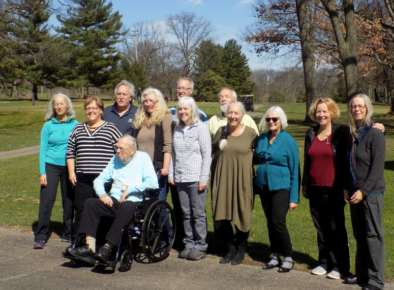 A group of people posing for a picture with one man in a wheelchair