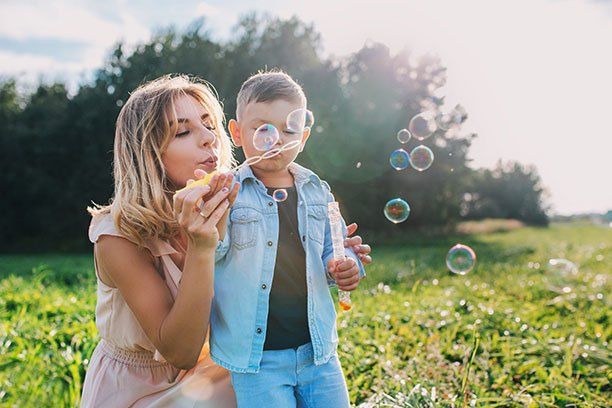 Mother and Son Blowing Bumbles — Belchertown, MA — Law Offices of Richard H Maynard PC