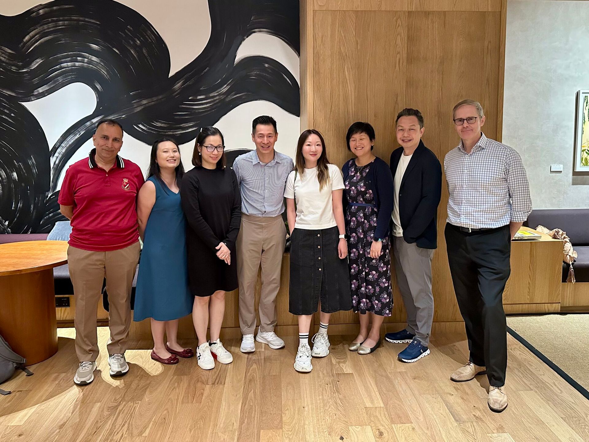 A group of people are posing for a picture in a room.