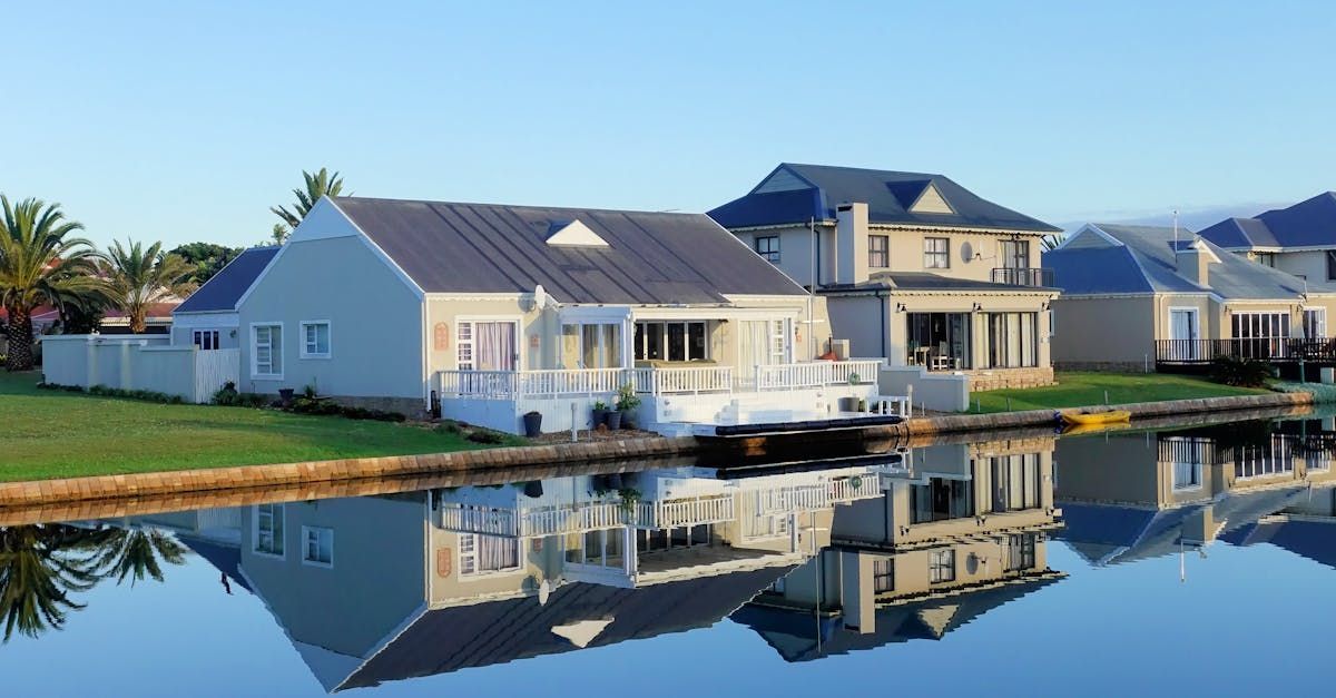A row of houses sitting next to a body of water.