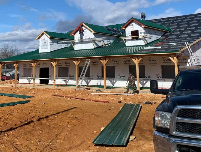 a truck is parked in front of a house under construction .