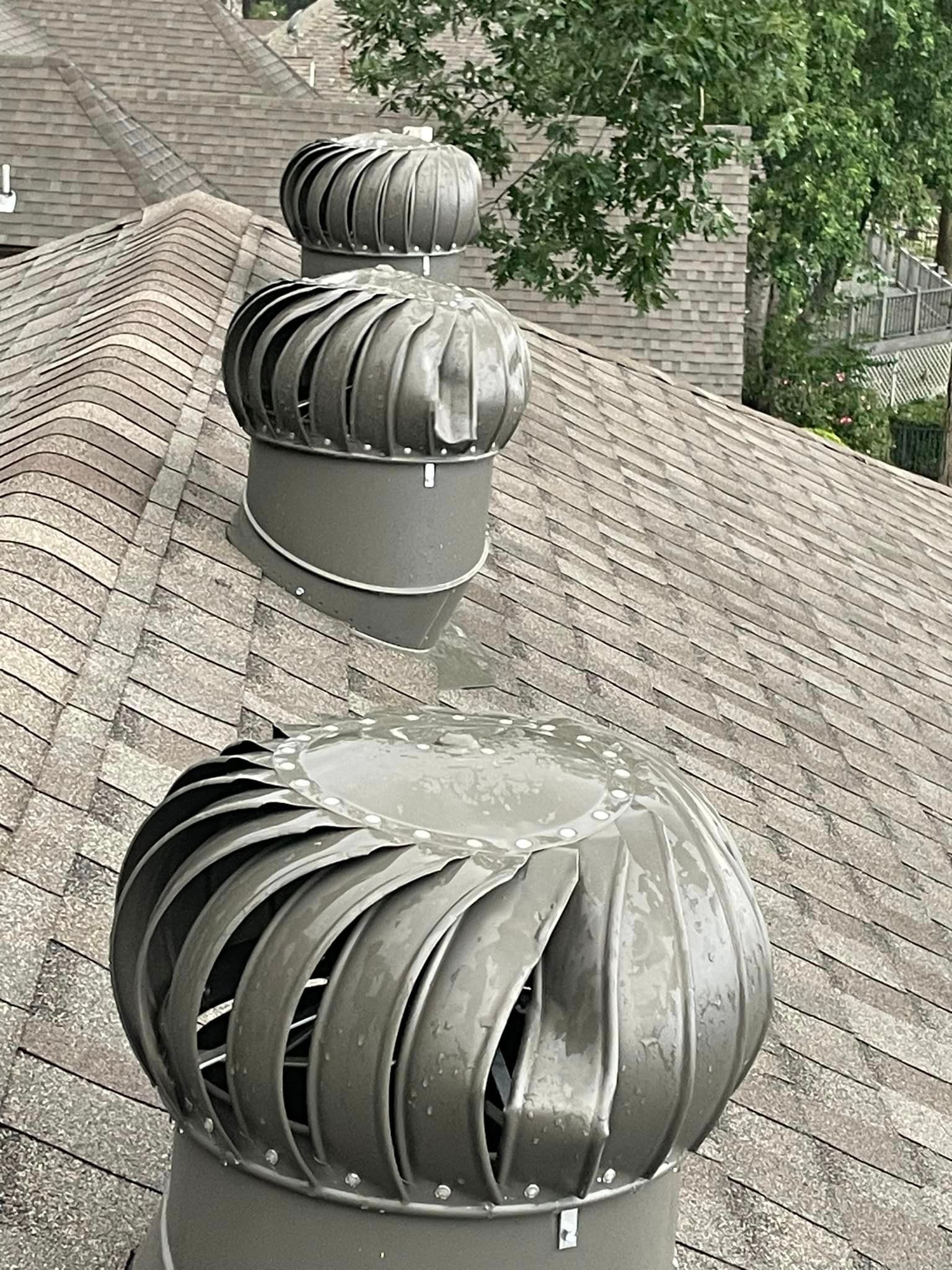 there are three turbines on the roof of a house .