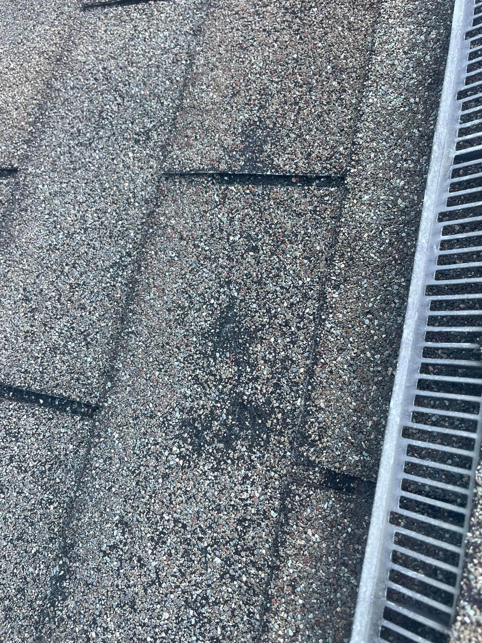 A close up of a roof with a drain on it.