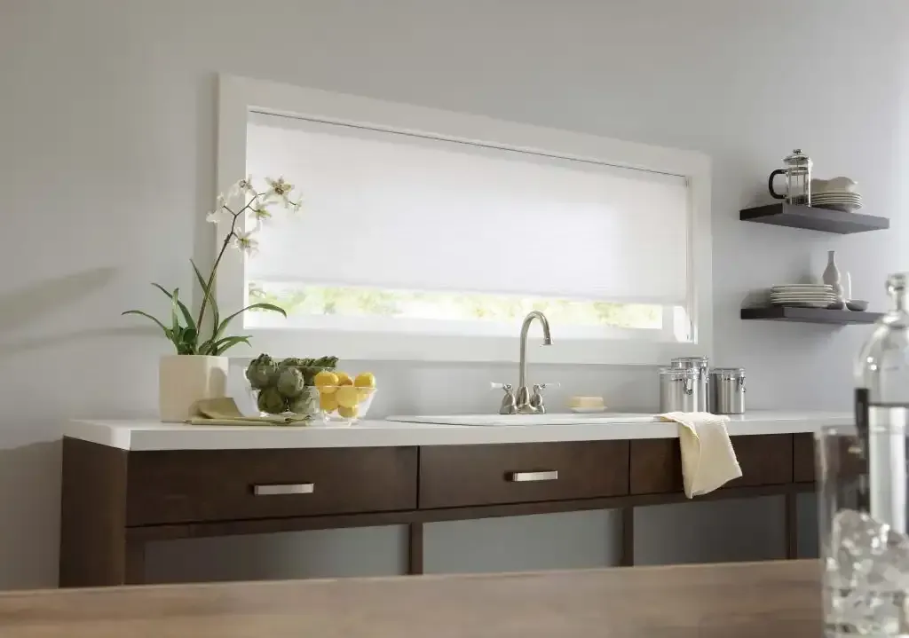 Kitchen with white roller shade, sink, dark wood cabinets, and floating shelves.