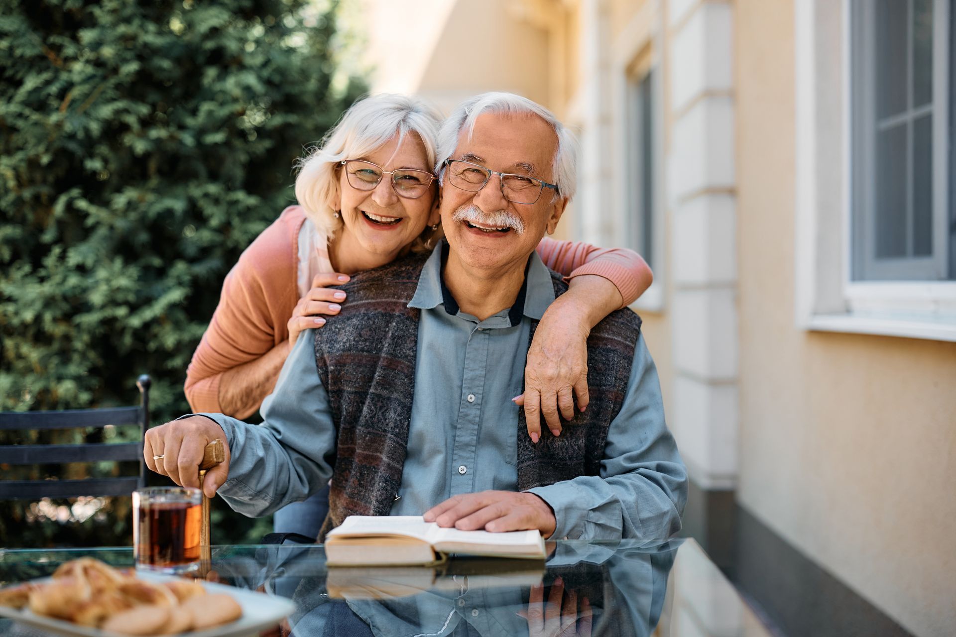 A happy senior couple having leisure time at an outdoor patio.
