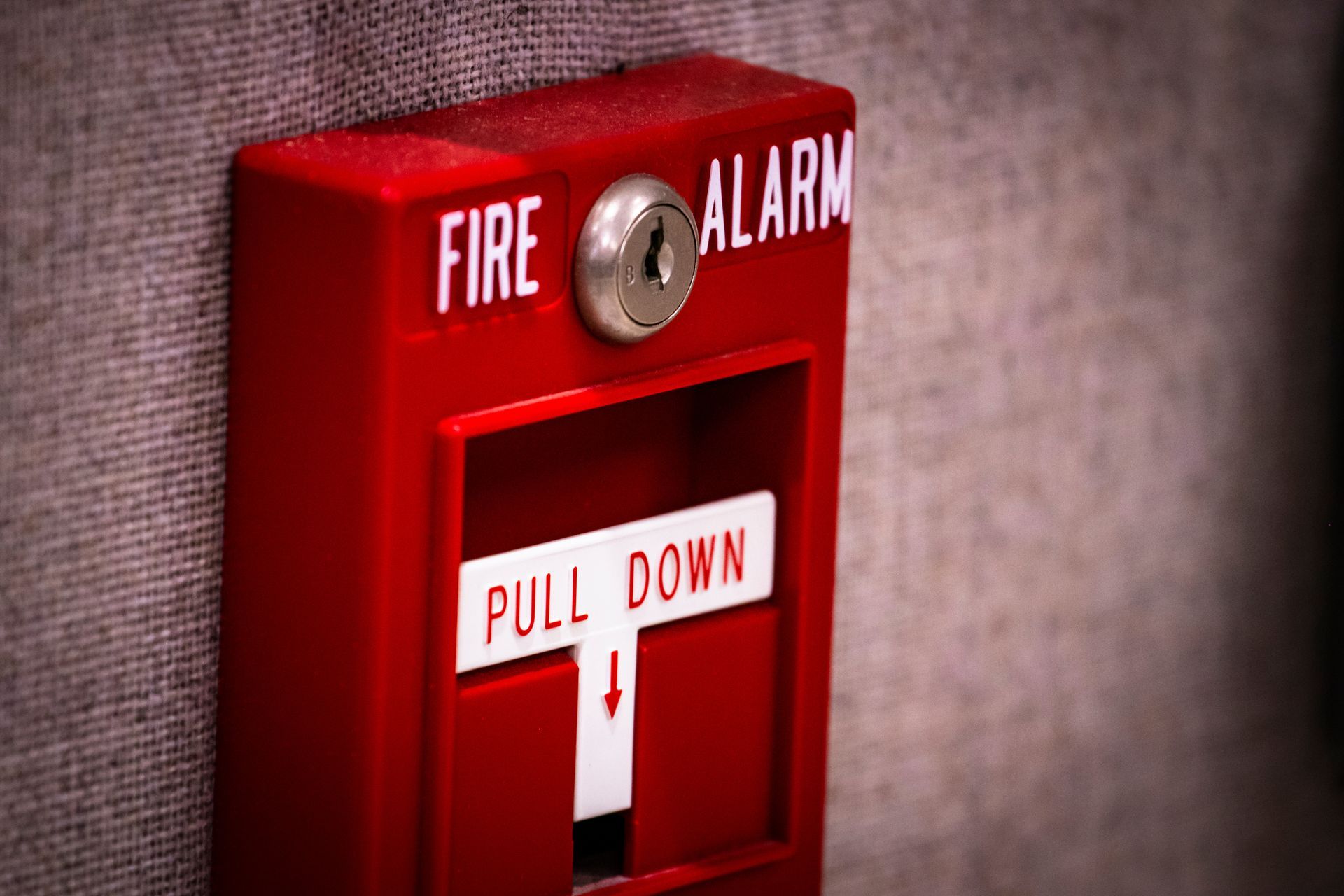Manual fire alarm activation pull station on wall. Manual fire alarm activation pull station on wall.