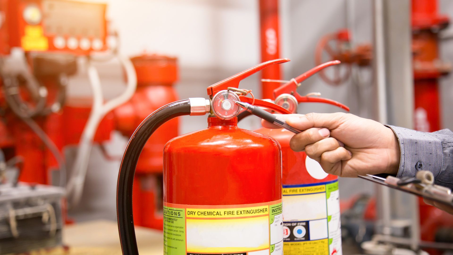 A person holding a fire extinguisher A person holding a fire extinguisher