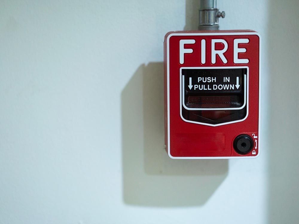 Close Up of a Fire Alarm Signal on Brick Wall 