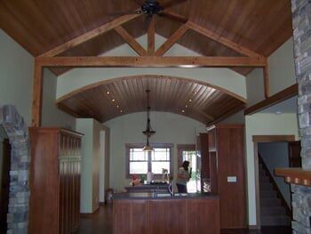 A kitchen with wooden cabinets and a ceiling fan
