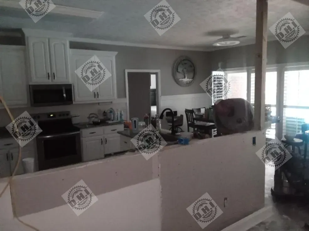 Kitchen remodel in progress; white cabinets, stainless steel appliances, open concept with neutral paint and visible construction.
