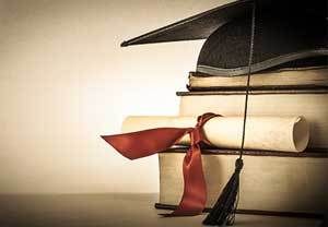 diploma with graduation hat on top of books