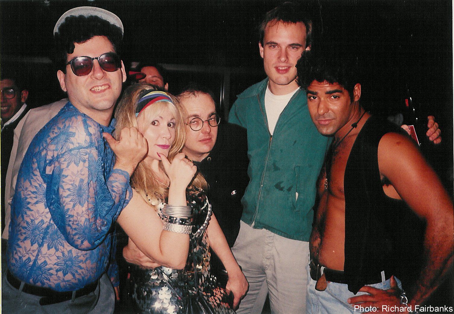 A group of people are posing for a photo and one of them is wearing sunglasses