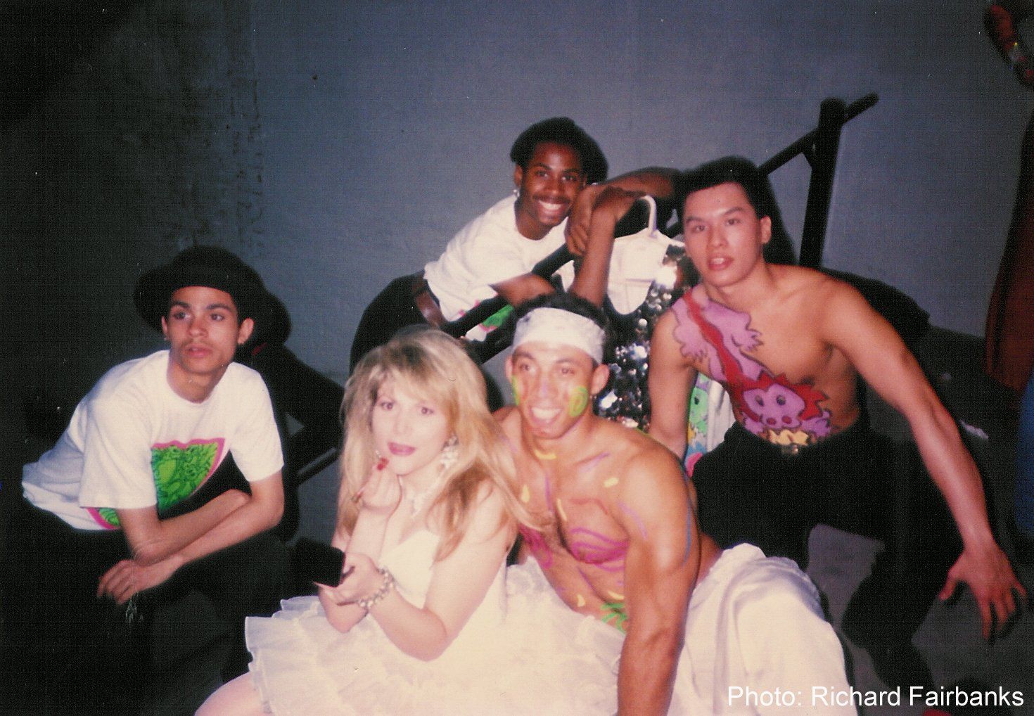 A group of people are posing for a photo and the photo was taken by richard faitance