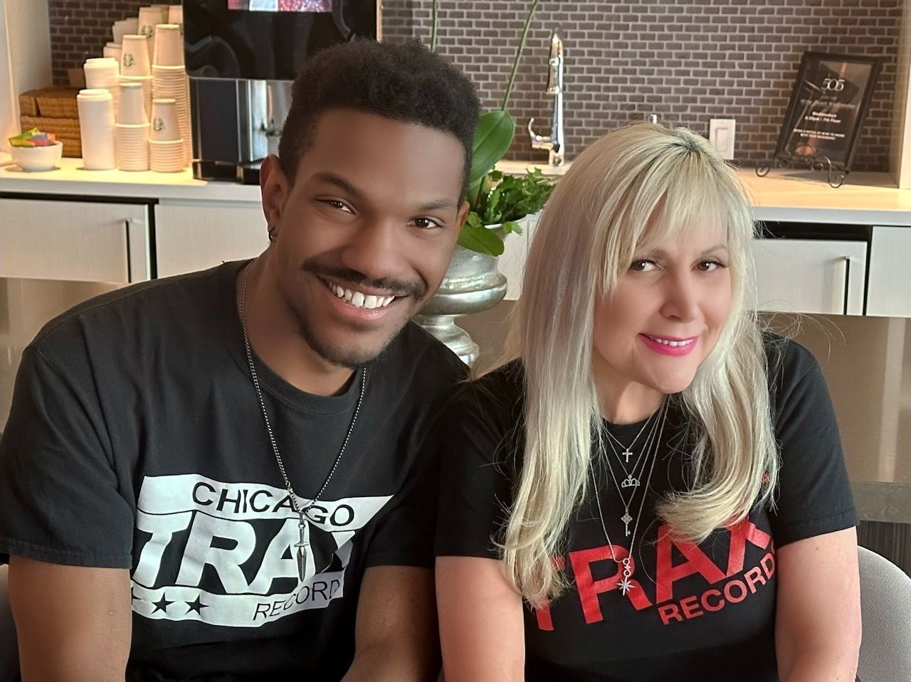 A man and a woman are posing for a picture and the man is wearing a chicago tray shirt