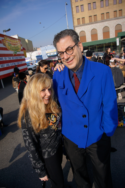 A man in a blue jacket is standing next to a woman