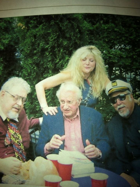 A group of people sitting around a table with red cups