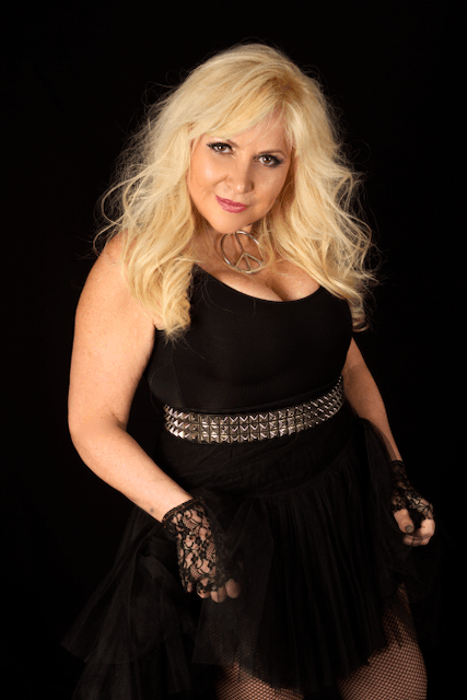 The woman is wearing a black dress and black gloves.