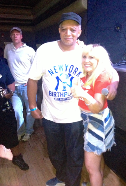 A man wearing a new york shirt stands next to a woman