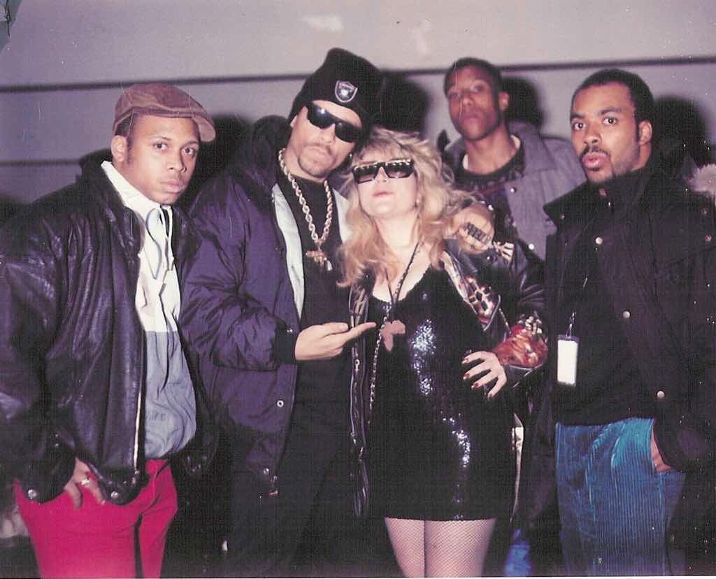 A group of men and a woman pose for a photo