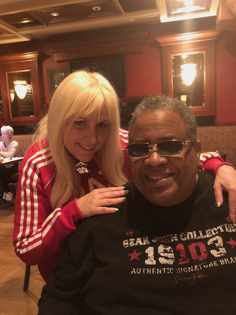 A man and a woman are posing for a picture in a restaurant