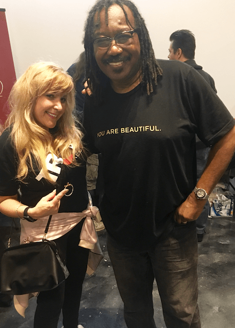 A man and a woman are posing for a picture . the man is wearing a shirt that says we are beautiful.