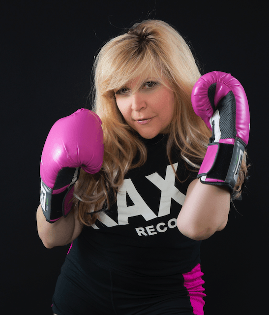 A woman wearing boxing gloves and a shirt that says ax