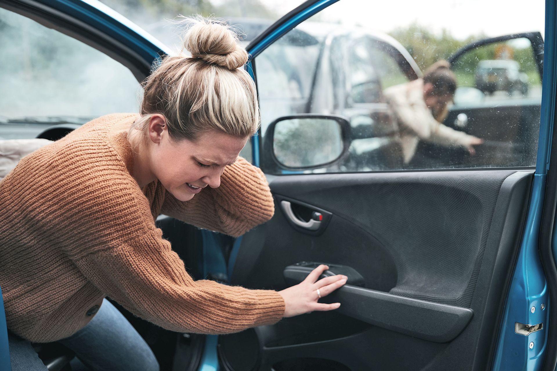 woman in auto accident holding neck in pain