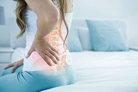 woman holding her back