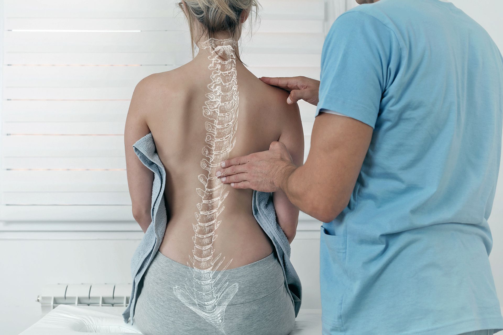 chiropractor checking patient's spine