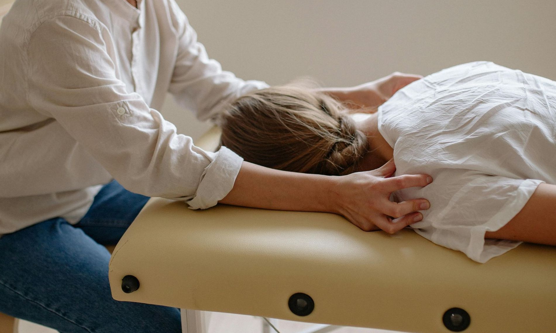 A woman is getting a massage on a table.