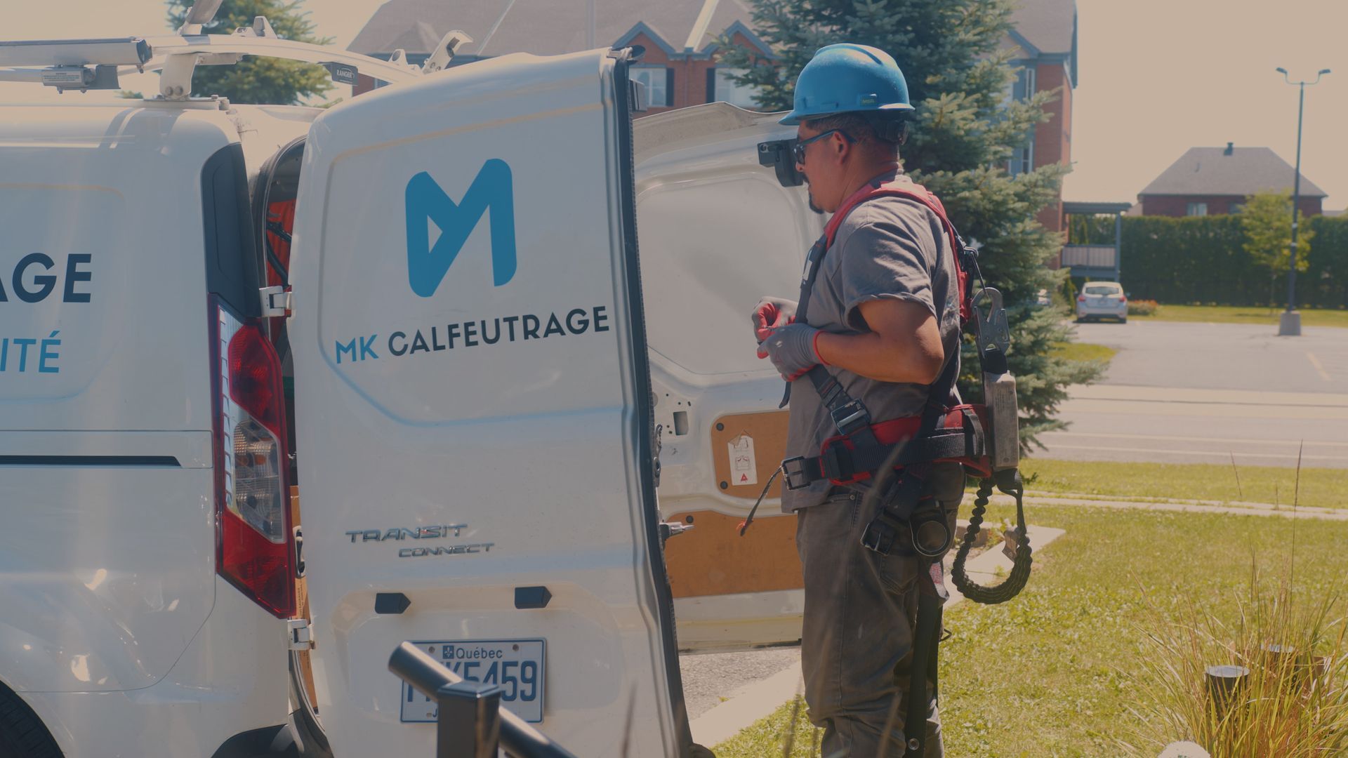 Man in work attire near a white van with 