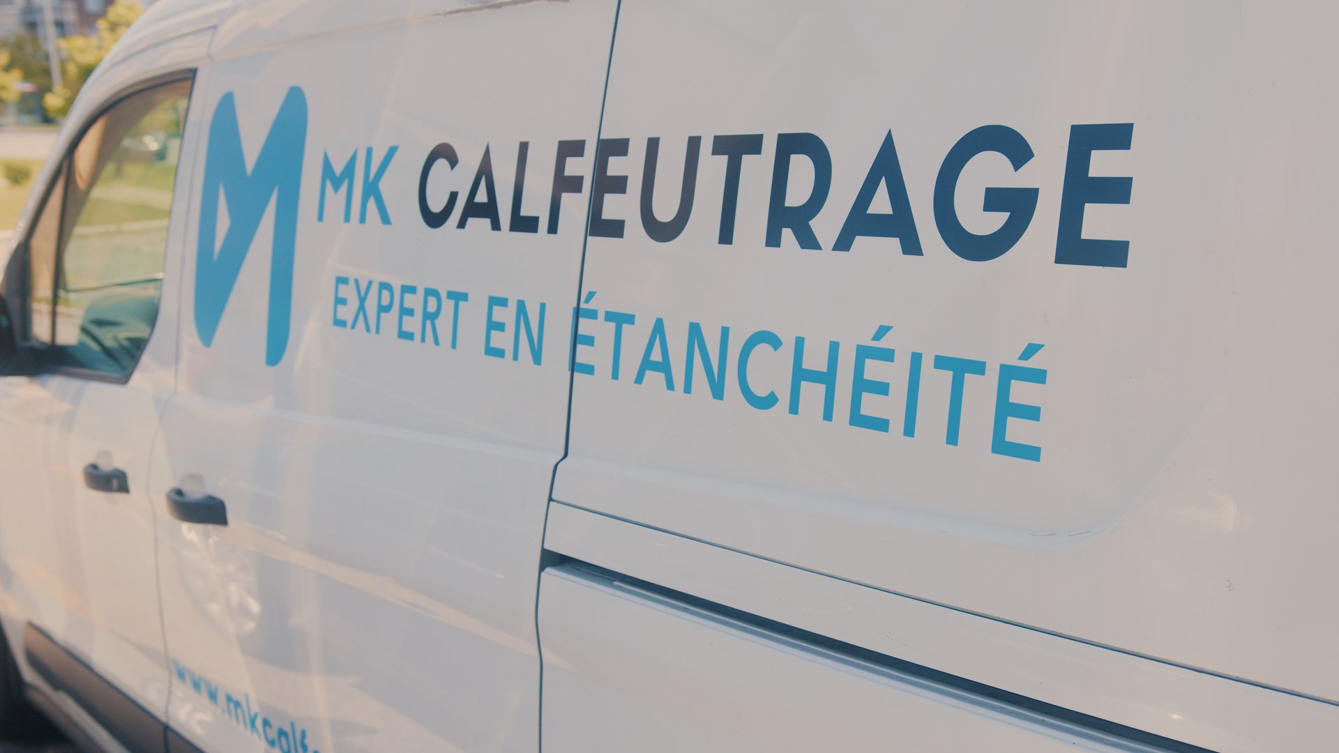 White van with blue logo reading